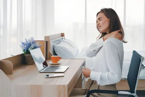Potenza ergonomic laptop holder on a modern wooden desk with a laptop, keyboard, and plant promoting better posture and focus in Greater London, UK.